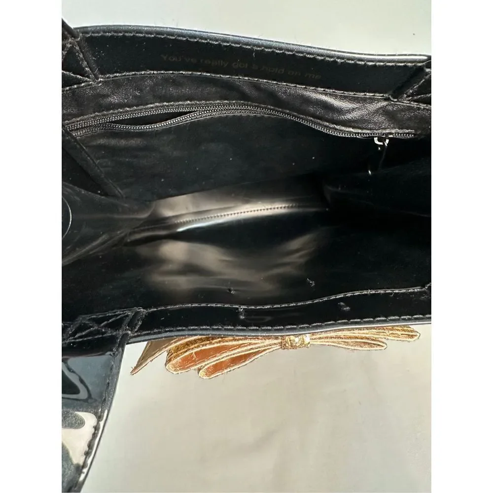 Ted Baker London Icon vinyl handbag with gold bow.    M-0927